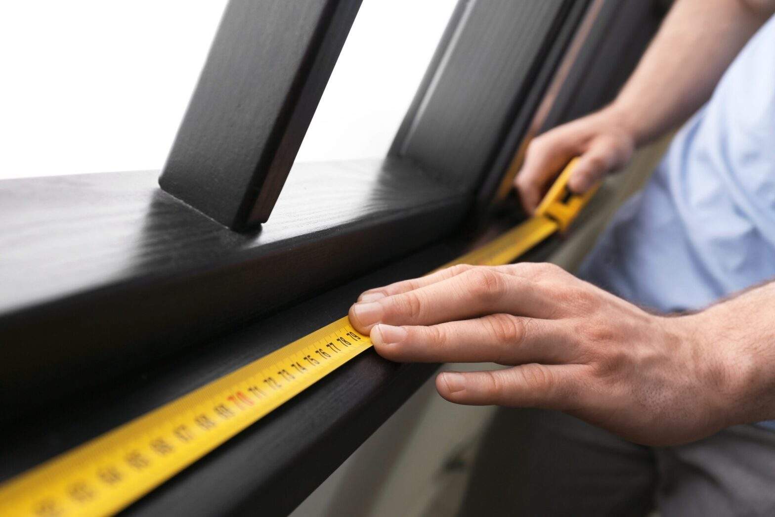 Men are measuring a window.